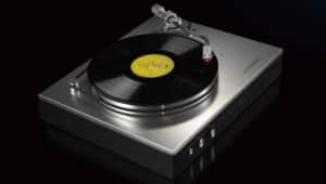 A sleek Luxman Audio turntable playing a vinyl record.