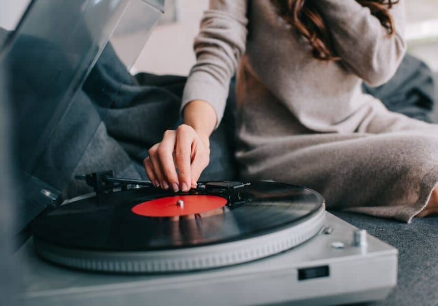 A woman playing a vinyl record.